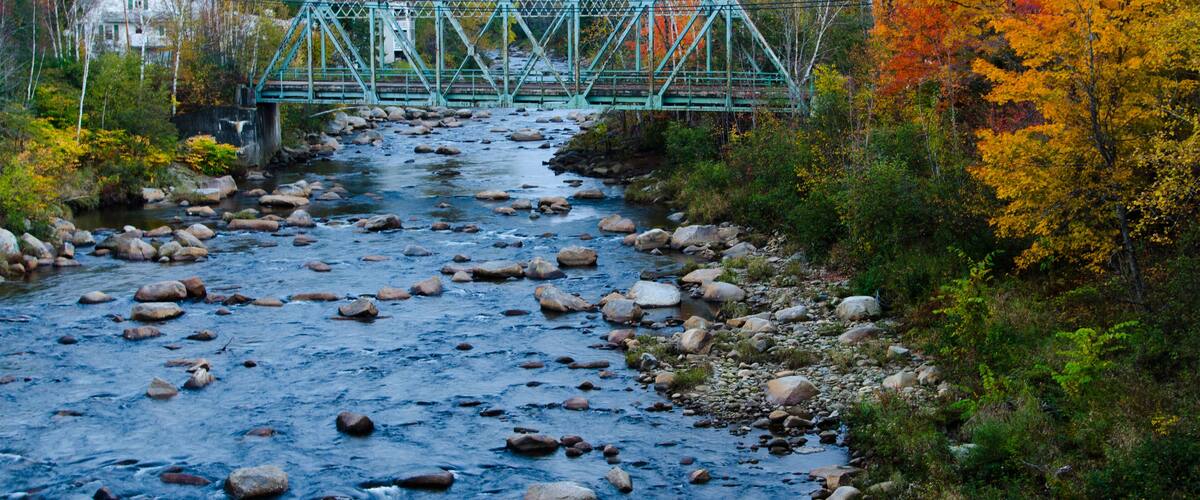 DW47GG Bethlehem New Hampshire old train bridge built in 1920 over river in Northern New England in fall foliage in October