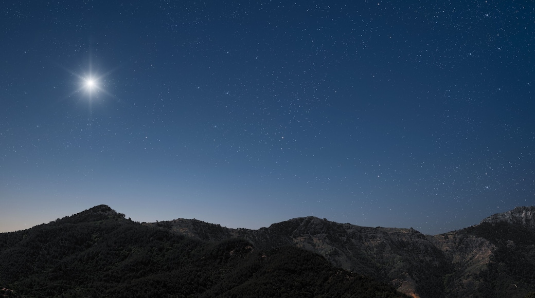 a Christmas star shines at night over the mountains of Bethlehem