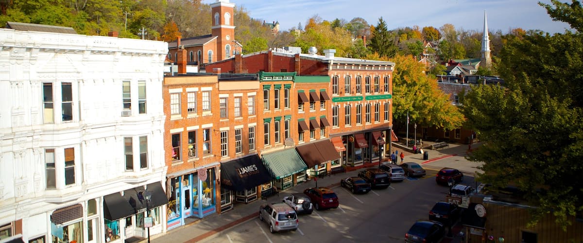 A historic downtown street with vintage buildings, a church steeple, and a prominent clock tower.