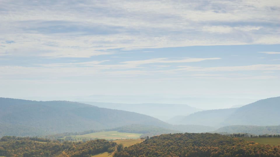 A mountainous landscape with rolling hills and a valley.