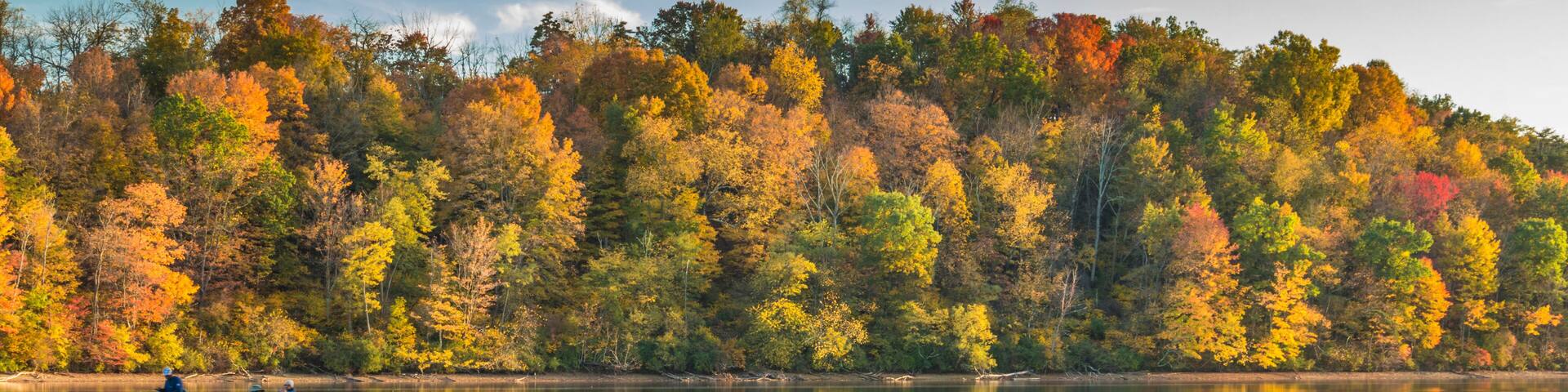 reflection of vibrant colorful peak autumn foliage of trees in the serene Lake Habeeb in Rocky Gap State Park in Western Maryland Allegany county.
