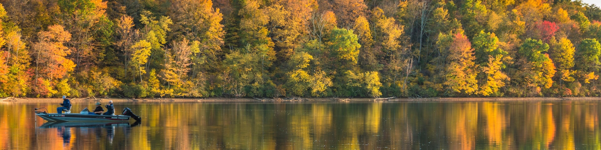 reflection of vibrant colorful peak autumn foliage of trees in the serene Lake Habeeb in Rocky Gap State Park in Western Maryland Allegany county.