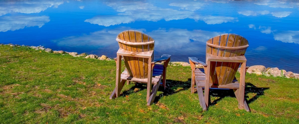 Two chairs on Fourth Lake ( Fulton Chain Lakes ) in the Adirondack Mounations of New York State