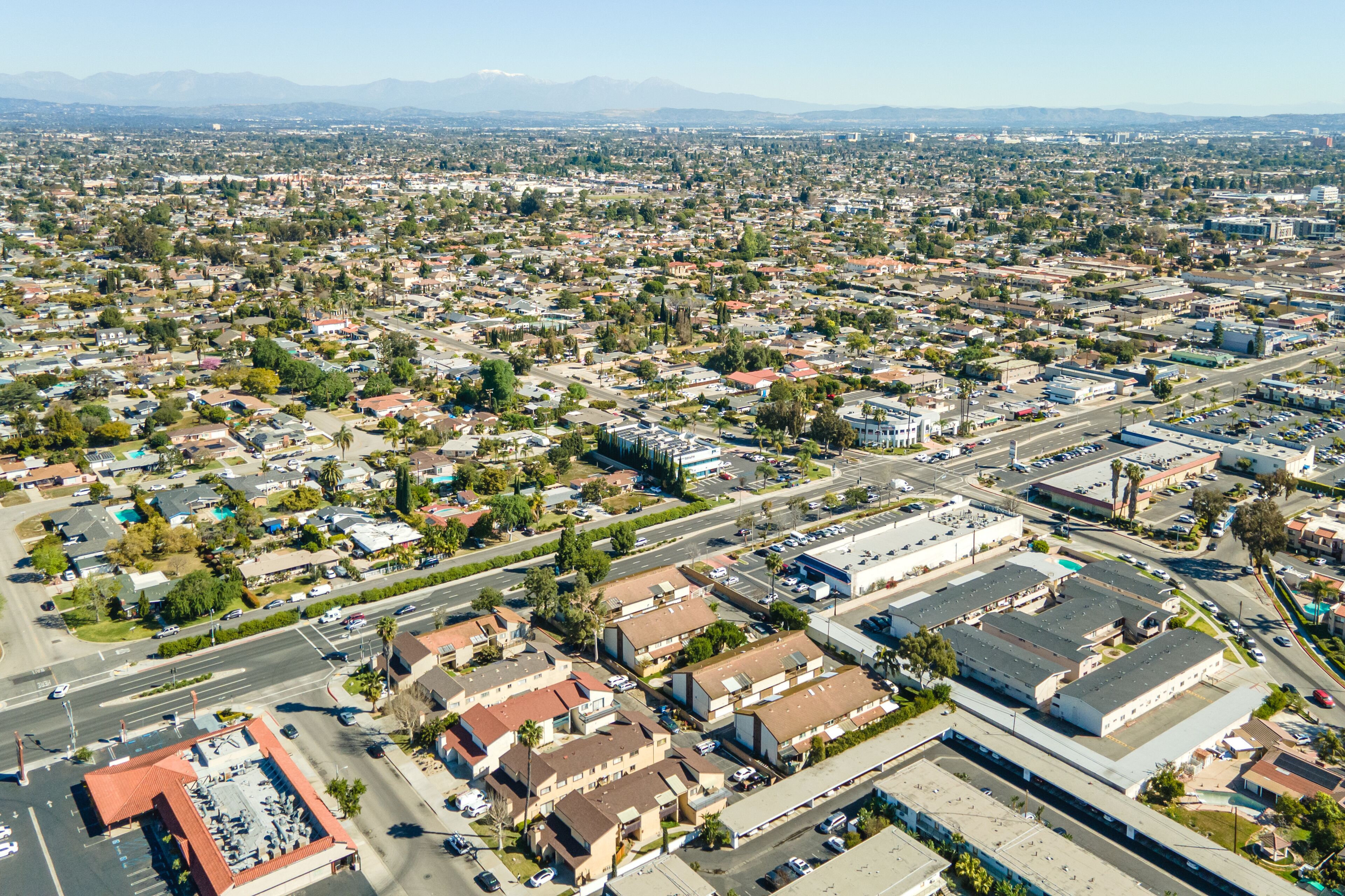 An aerial view of a densely populated urban area with numerous buildings, roads, and green spaces.
