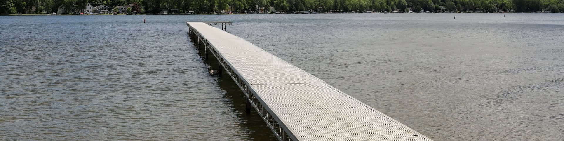 View of Conesus lake and boat dock at Long Point beach park. Geneseo, New York.