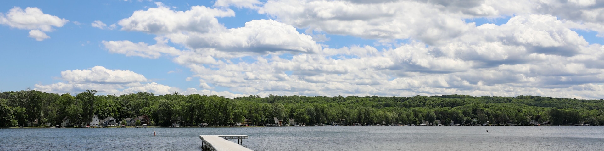 View of Conesus lake and boat dock at Long Point beach park. Geneseo, New York.