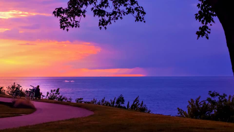 People taking a break on a bikeride, overlooking Lake Erie in Geneva-On-The-Lake, Ohio