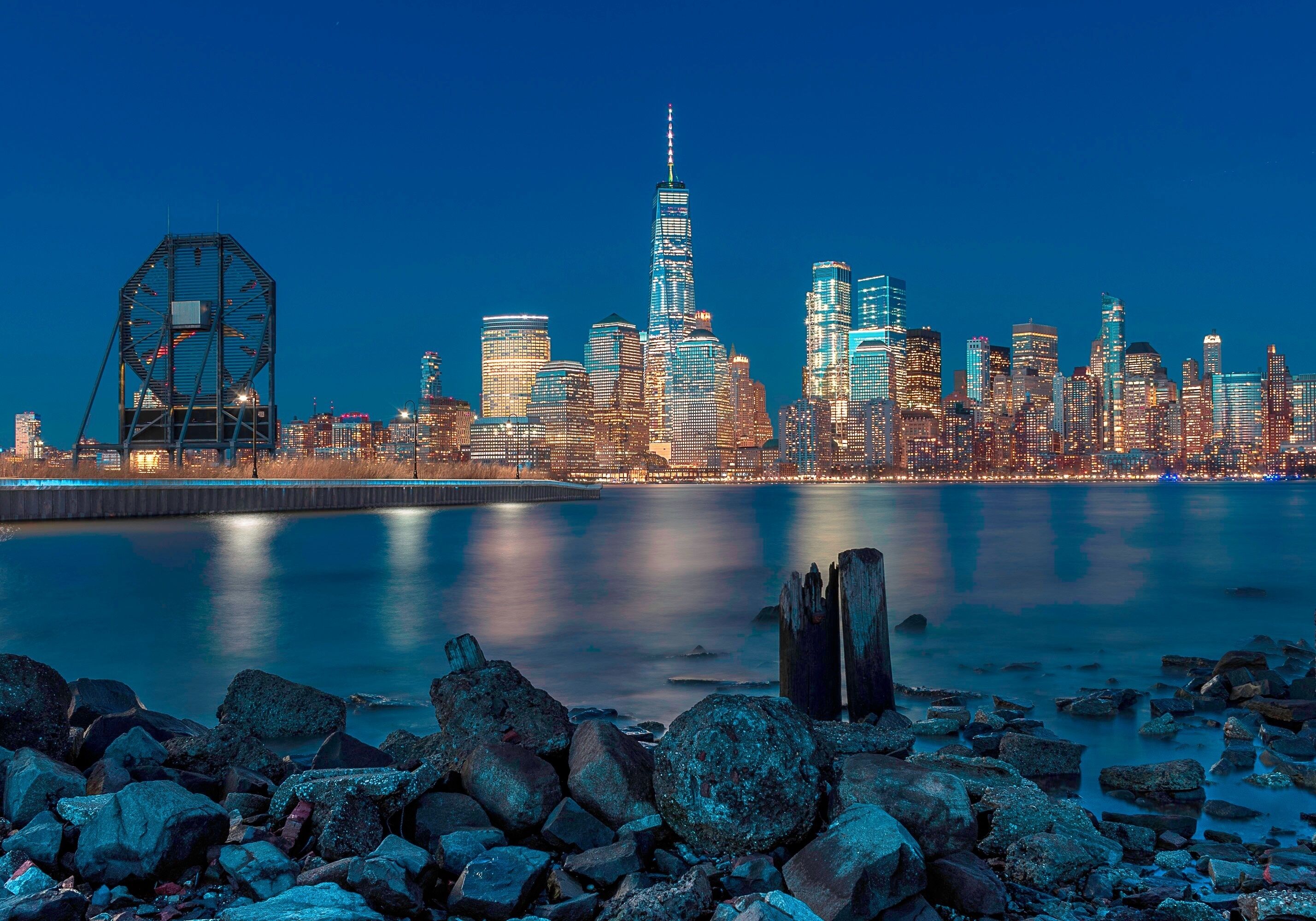 NYC from NJ. This is the view of downtown New York from the Morris Canal Park in Jersey City, NJ. The park itself is right in the heart of Jersey City about a half mile from the Path Train Station and the NYC Taxi Waterway. It’s a small patch of land in the midst of high rise apartments. While I was there, I could see it’s a popular spot among nearby residents who make it a habit to end their hectic day with their children and pets while taking in the view of the financial district as well as the Colgate clock in the foreground. It’s a peaceful and friendly neighborhood as well as I had the opportunity to strike up conversations with several locals. 