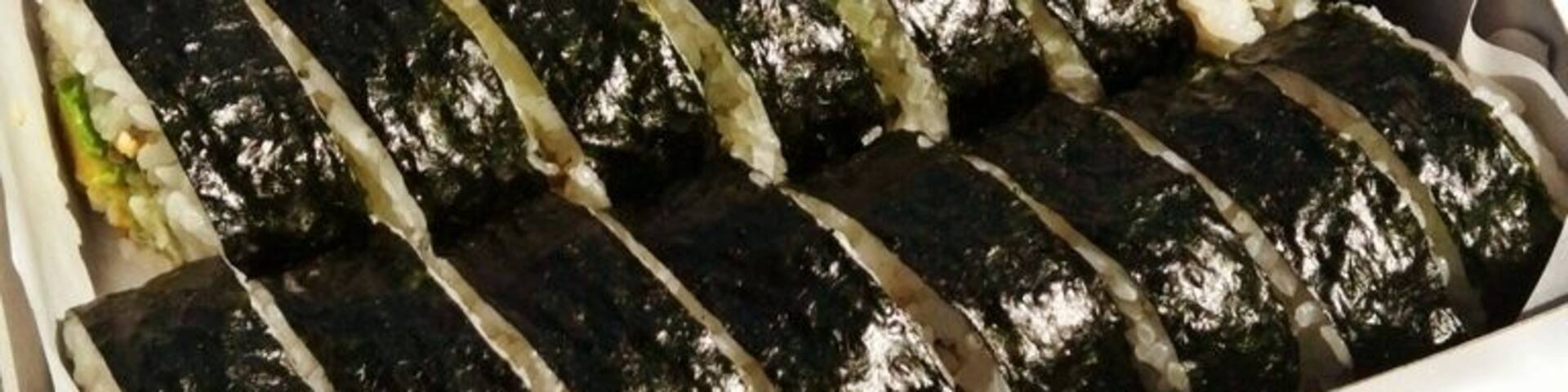 Freshly made inari and nori sushi bento unwrapped in the car