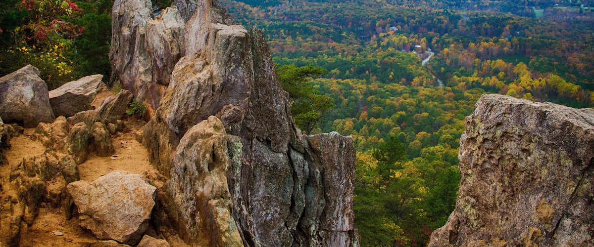 Crowders Mountain State Park has a wealth of great trails which end with great views of North Carolina piedmont. The two main destinations are Crowders Mountain (2.8 mile walk from Sparrow Springs Access) or the Pinnacle or King's Pinnacle. The Pinnacle trail is a pleasant 2 miles trek uphill through rich forest. The last little bit has some rock scrambling with signs that urge carefulness. But the views are stupendous, especially with fall colors in full display. (About 45 minutes west of Charlotte, NC)