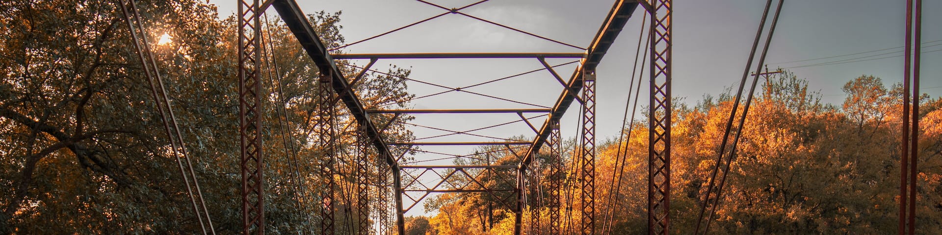 Historic 1904 Leon River Bridge in Gatesville, Texas. The artwork showcases the old, rustic bridge with its wooden deck and intricate metal framework.