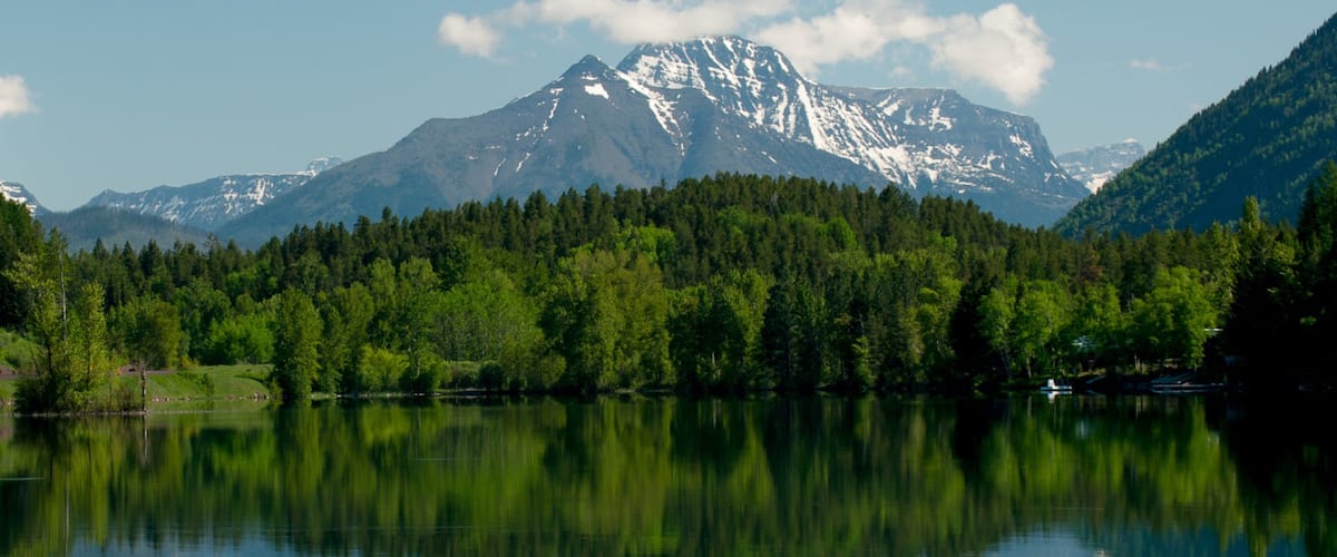 Bigfork showing a lake or waterhole, forests and mountains