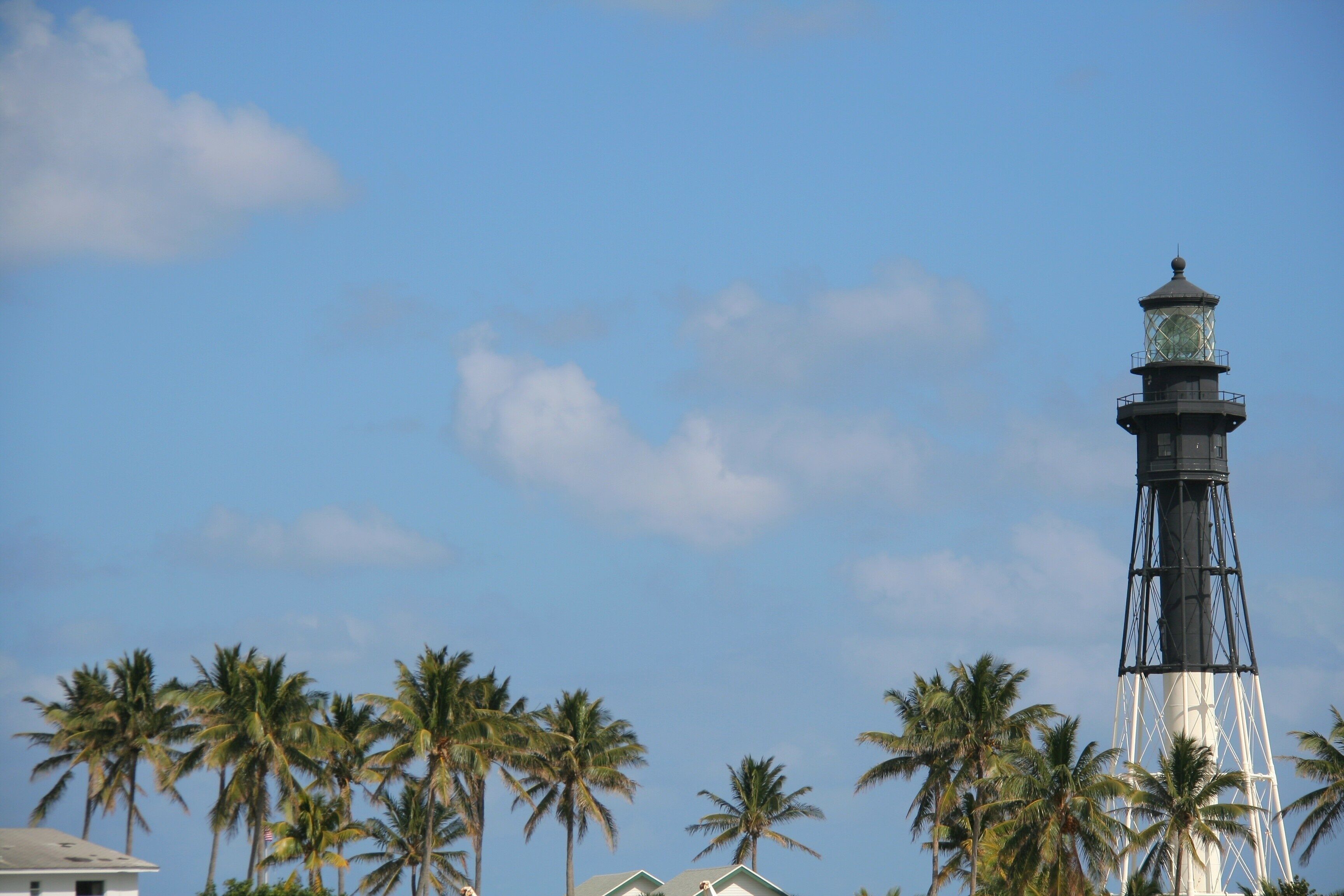 Top of Pompano Beach lighthouse in Mid-Afternoon in Springtime, Blue Sky with Scattered Clouds and Palm Trees Below, Lighthouse Point, Pompano Beach, FL
