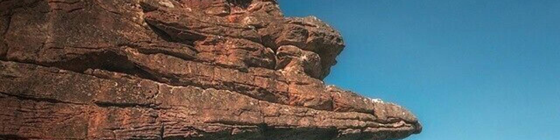 A rugged rock formation with a clear sky.