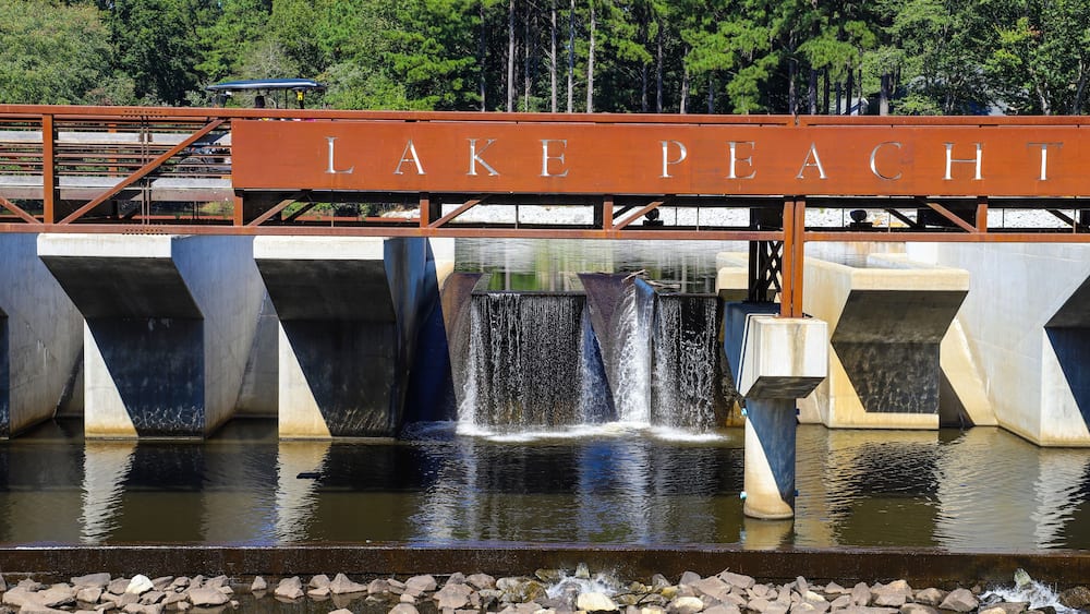 a gorgeous shot of the waterfall and the rushing water at Lake Peachtree in Peachtree City Georgia