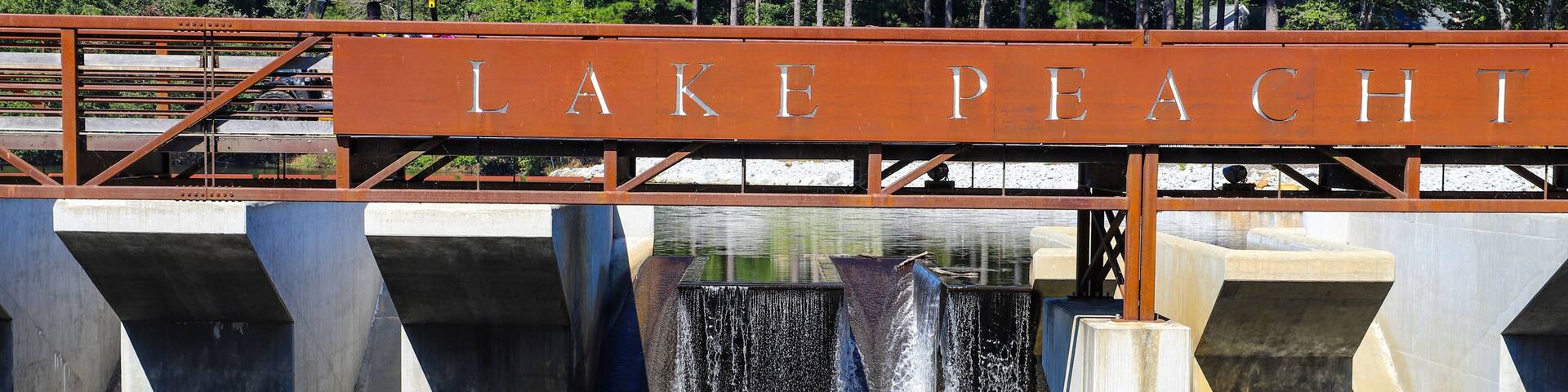 a gorgeous shot of the waterfall and the rushing water at Lake Peachtree in Peachtree City Georgia