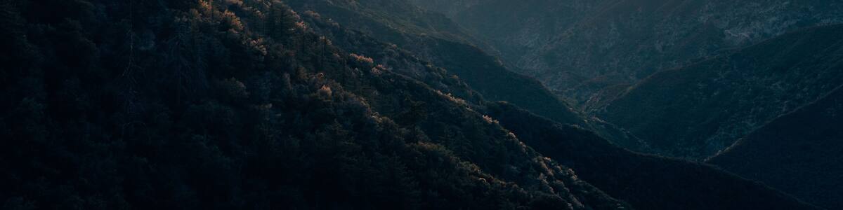 A mountain range at sunset with a clear sky.
