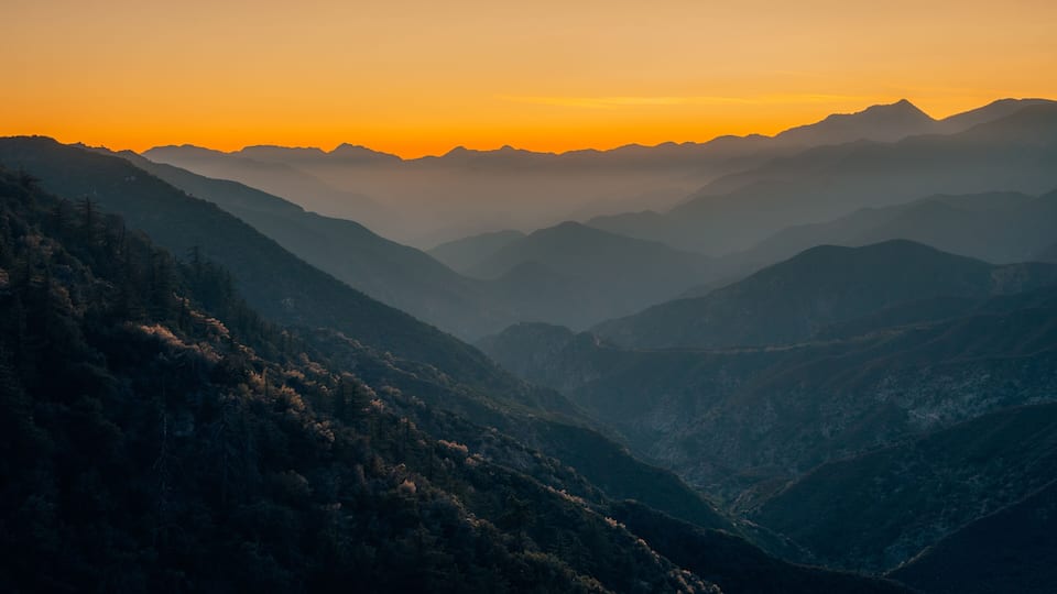 A mountain range at sunset with a clear sky.