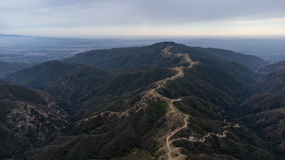 A mountain range with a winding trail.