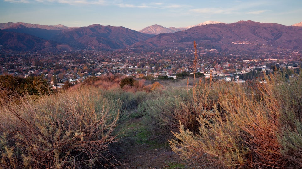 A town nestled in a valley with mountains in the background.