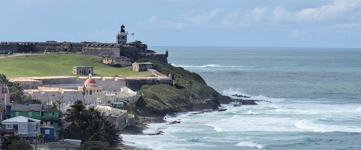 view of el morro form in old san juan puerto rico (coastal landmark national historic site) castillo castle spanish fortification next to la perla residential community