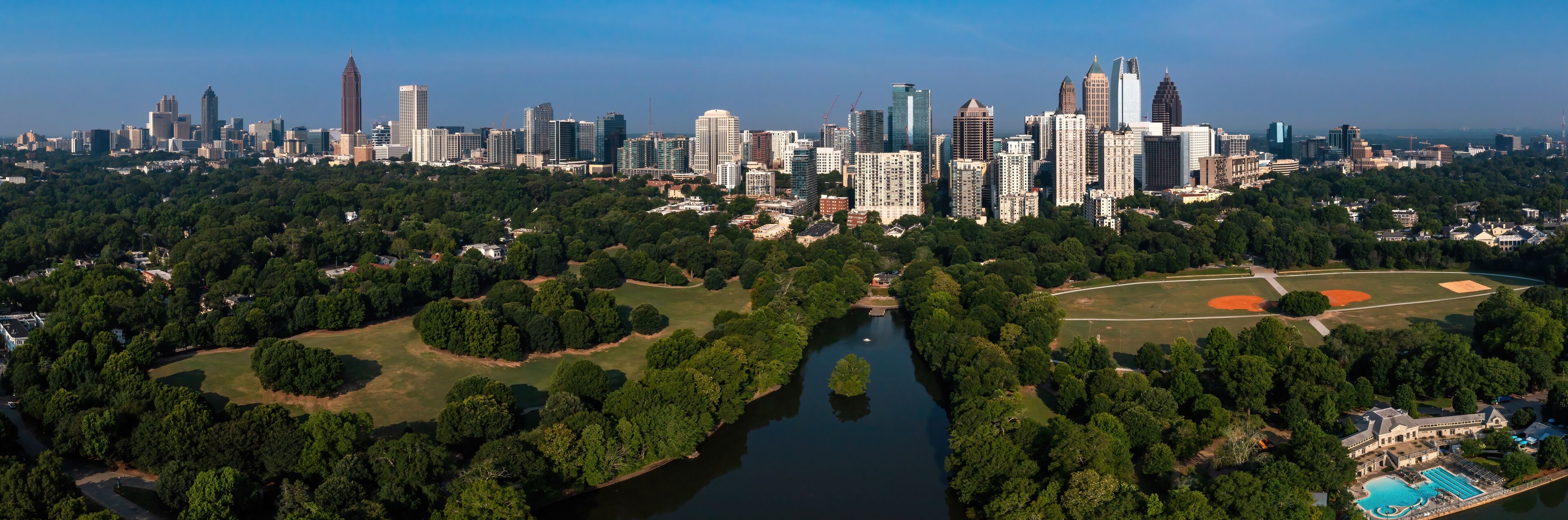 A city skyline with a river and park areas.