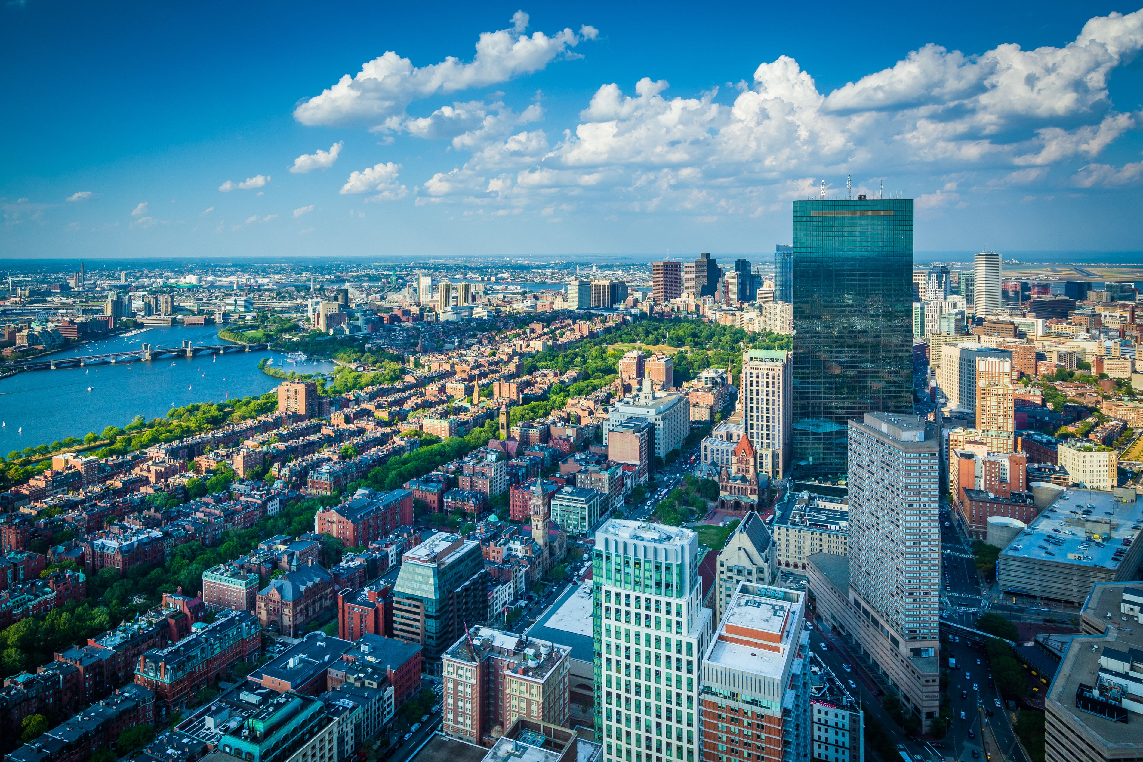 A cityscape with a prominent skyscraper, a river, and a mix of historic and modern buildings.