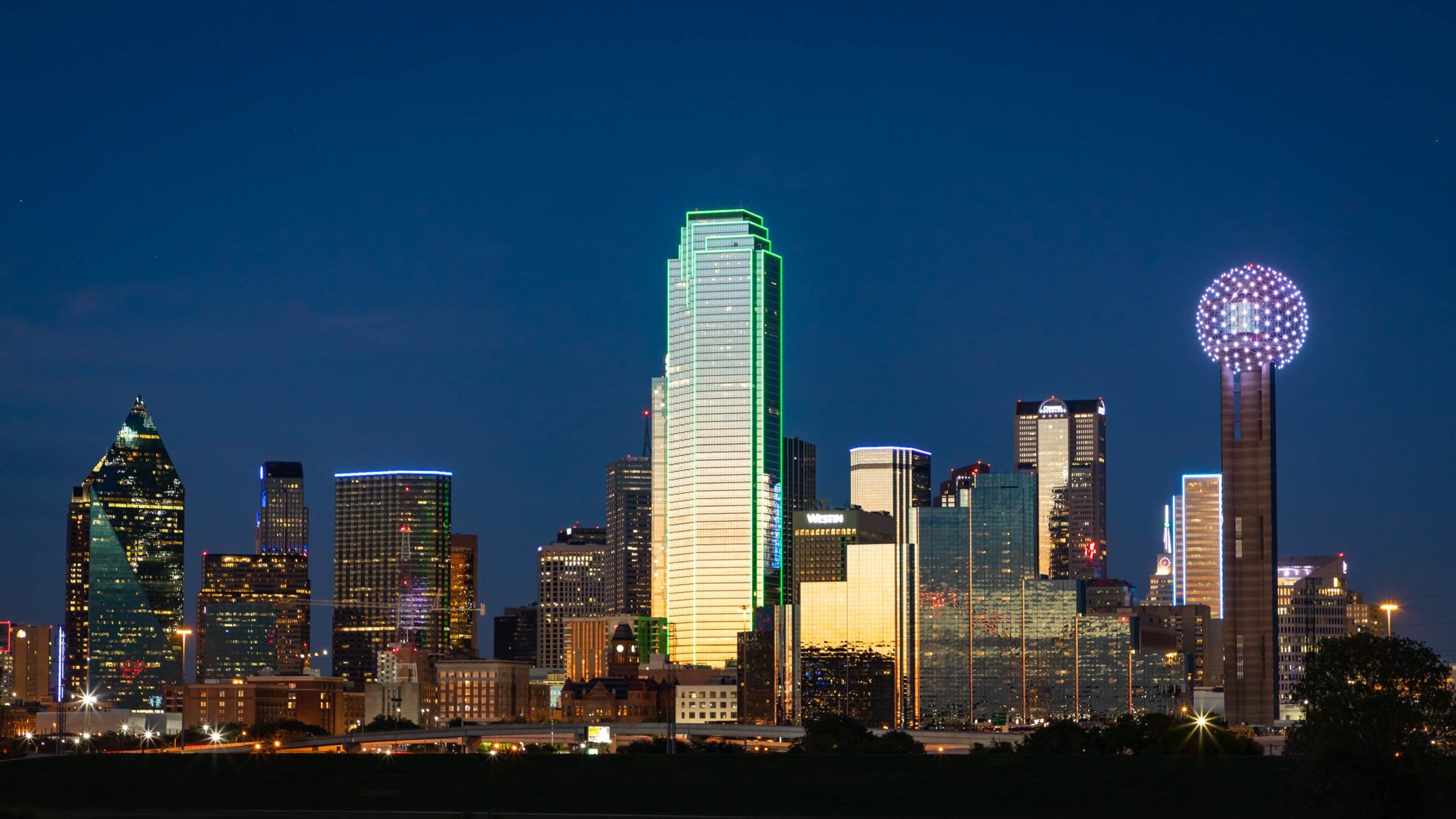 Downtown Dallas showing a city, a skyscraper and night scenes