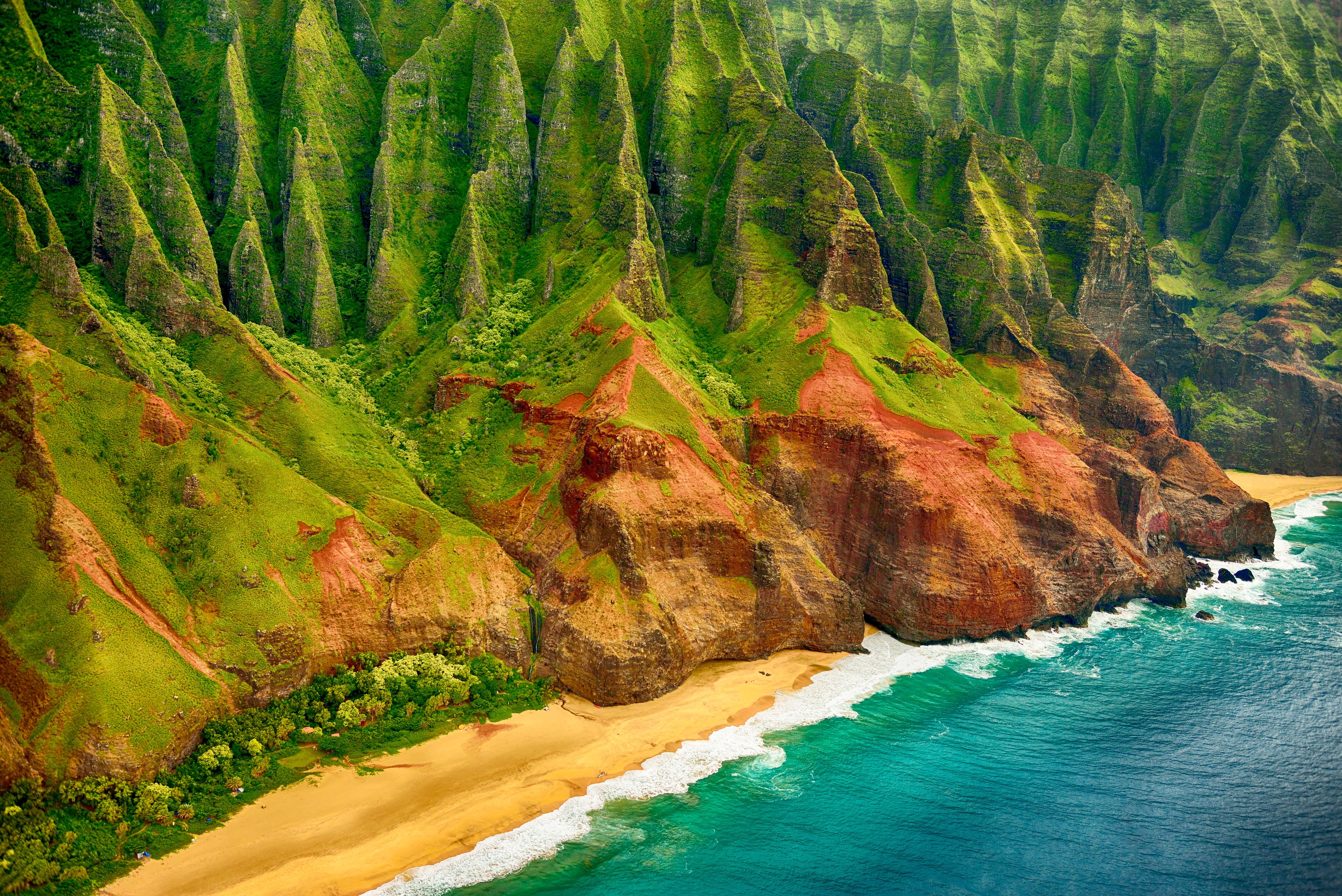 A coastal landscape with a beach, cliffs, and ocean waves.