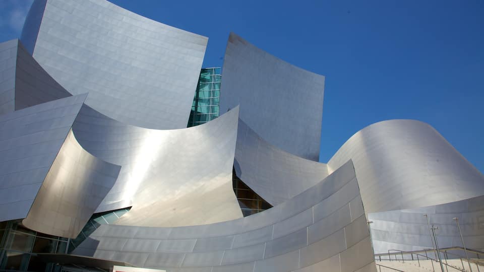 A modern architectural structure with curved metallic surfaces and glass windows.