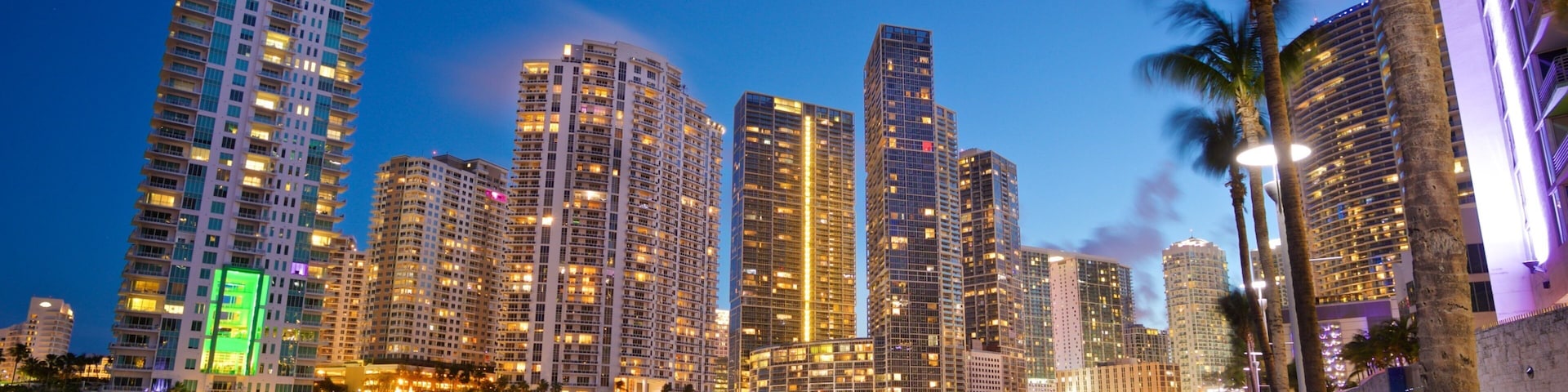 Downtown Miami which includes night scenes, a city and a river or creek