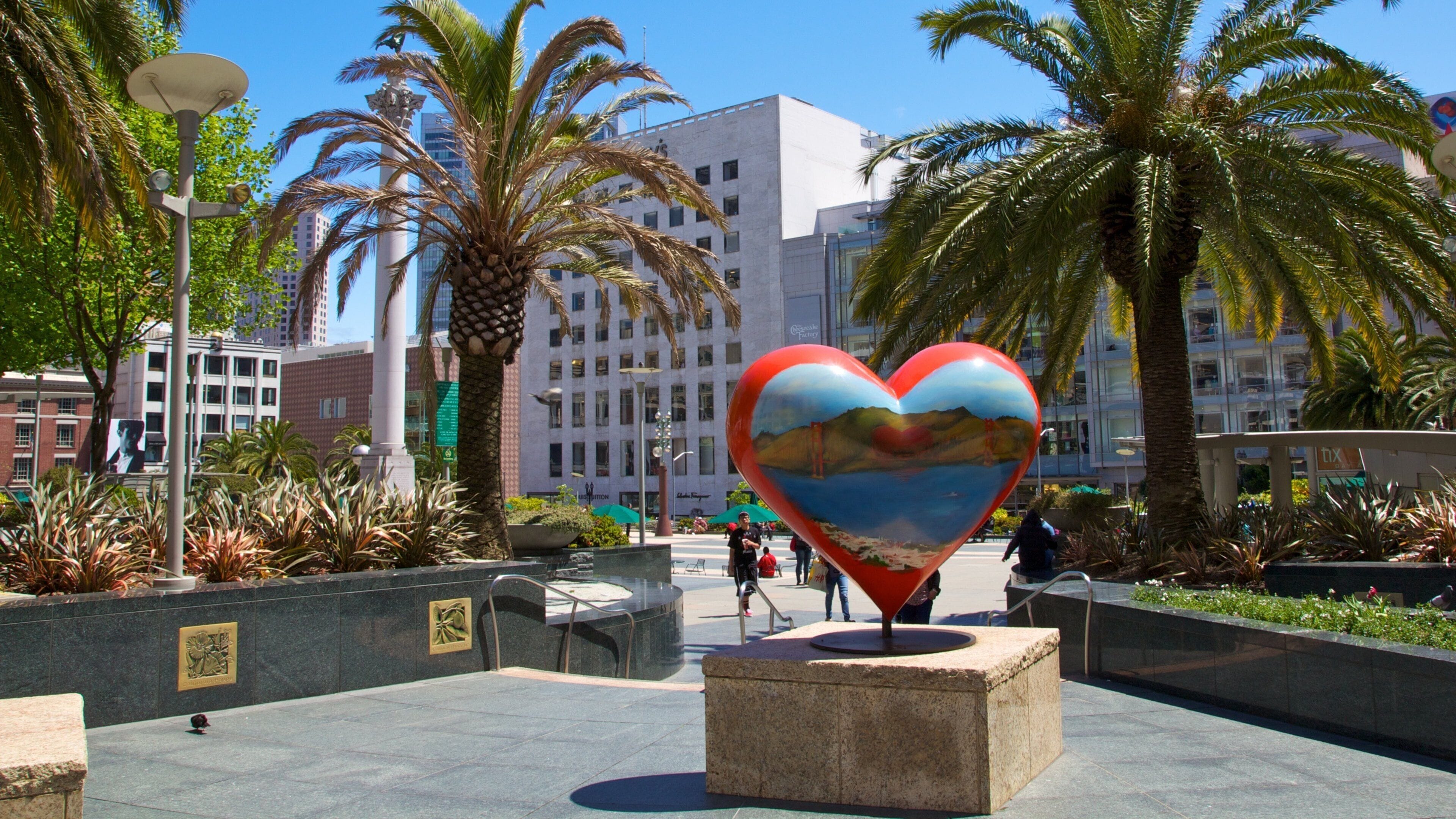 Colorful heart sculpture in Union Square surrounded by palm trees in San Francisco