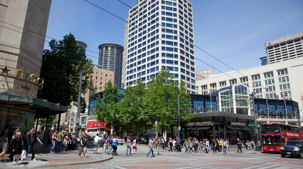Bustling downtown Seattle with modern architecture and lively pedestrians under a clear blue sky