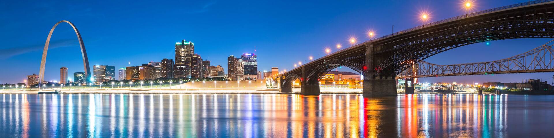 st. louis skyscraper at night with reflection in river,st. louis,missouri,usa.