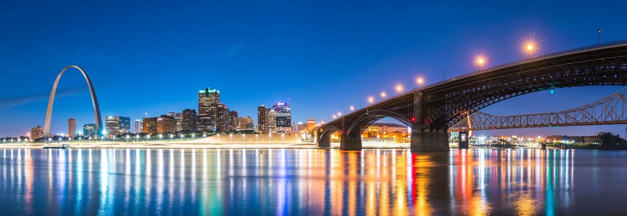 st. louis skyscraper at night with reflection in river,st. louis,missouri,usa.
