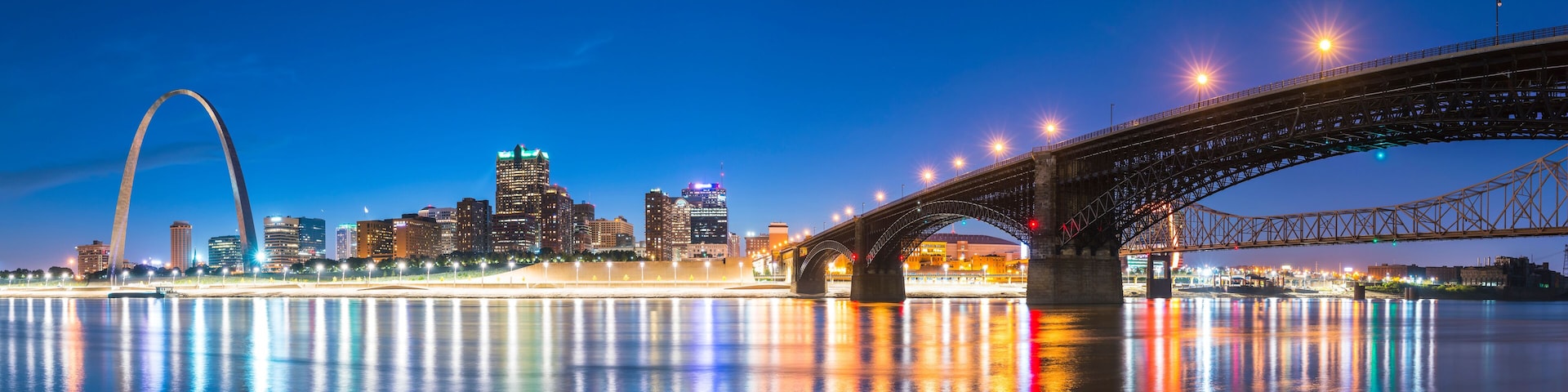 st. louis skyscraper at night with reflection in river,st. louis,missouri,usa.