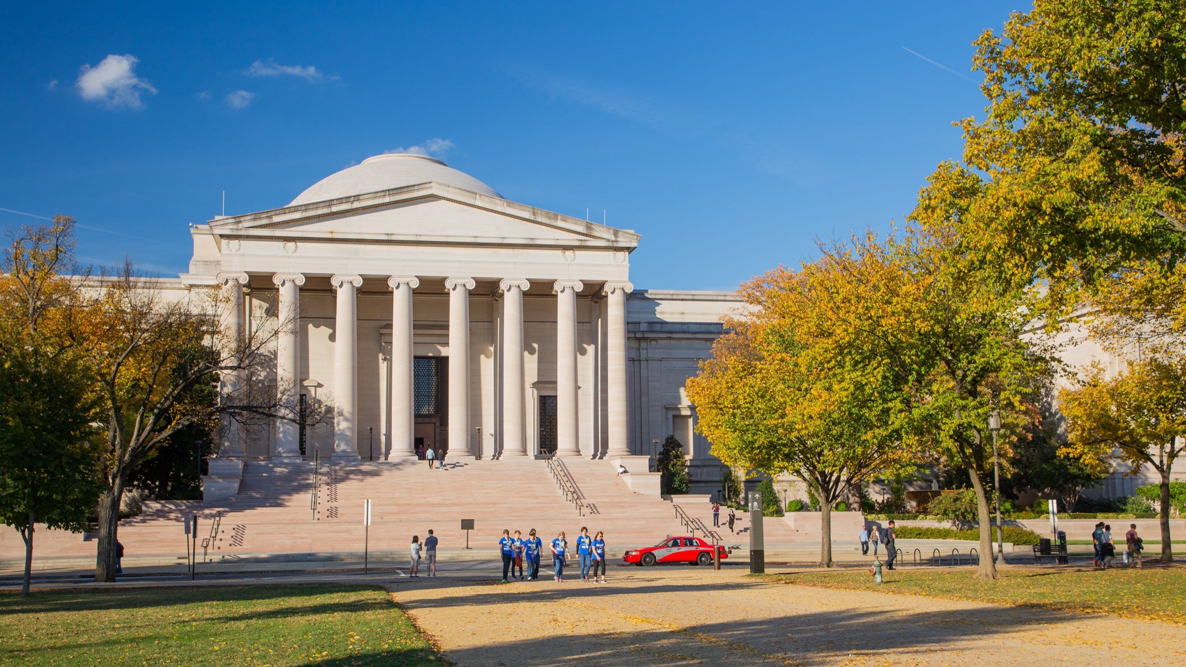 Downtown Washington D.C. which includes heritage architecture, an administrative buidling and autumn leaves