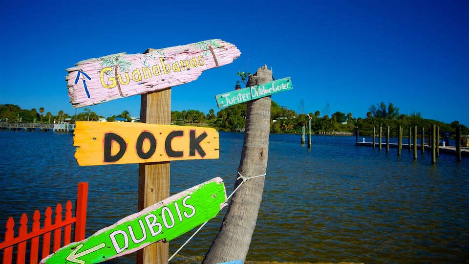A wooden signpost with directional signs for Guanabans, Dock, Jupiter, and Dubois.