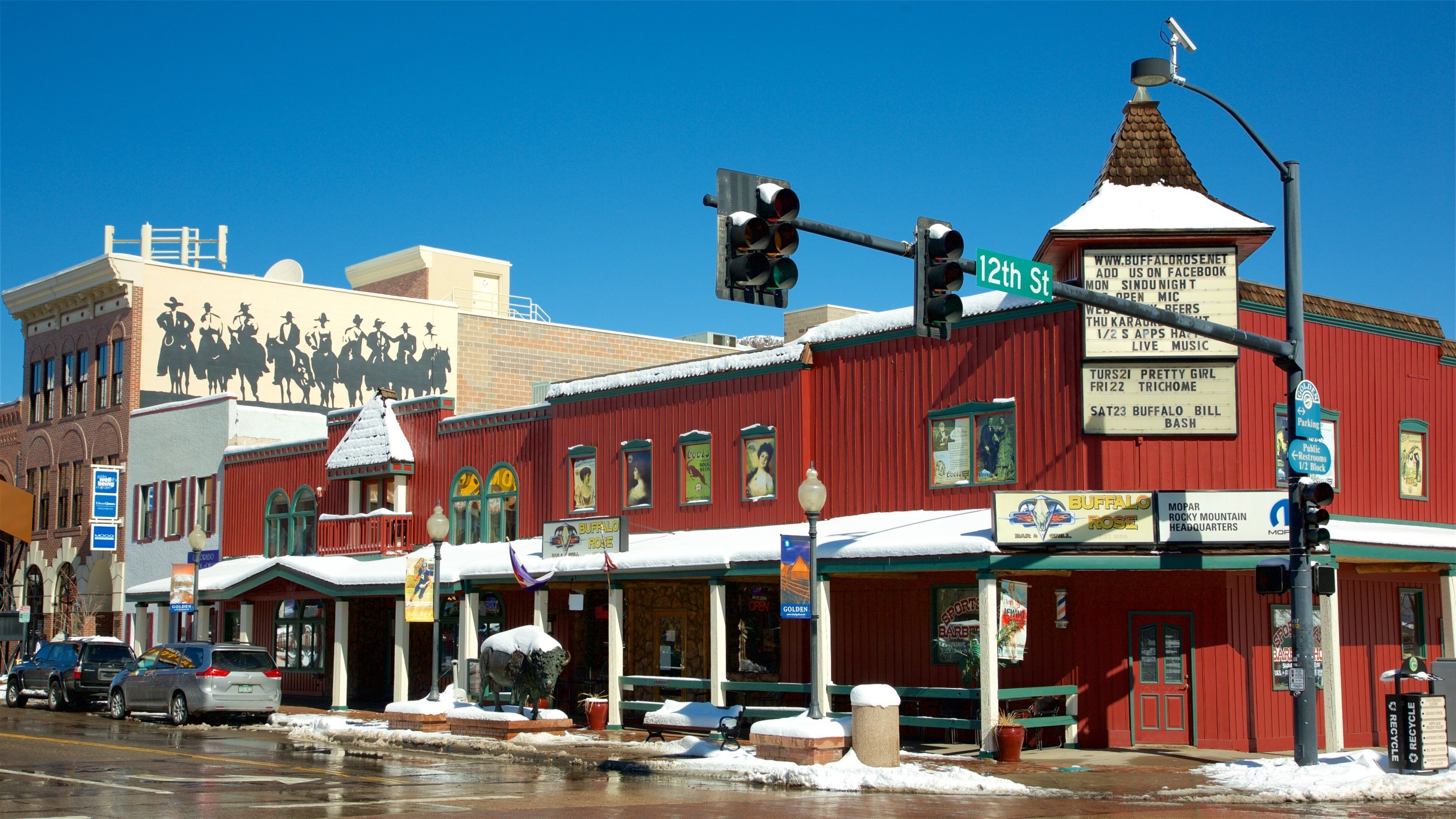 A red building with a snow-covered roof and a sign for Buffalo Rose.