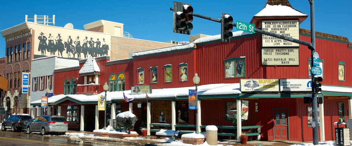A red building with a snow-covered roof and a sign for Buffalo Rose.