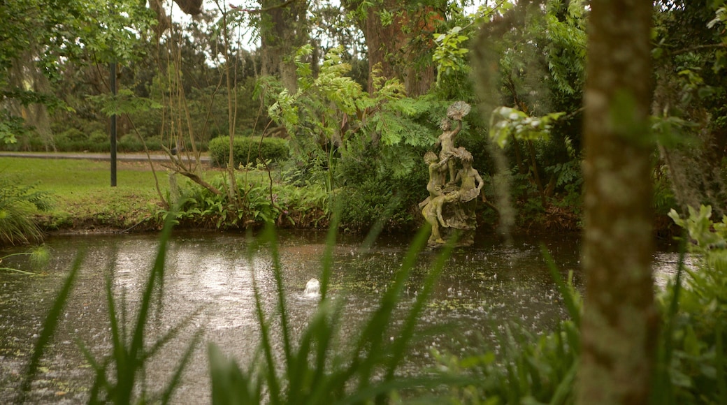 Gonzales which includes a pond, a garden and a statue or sculpture