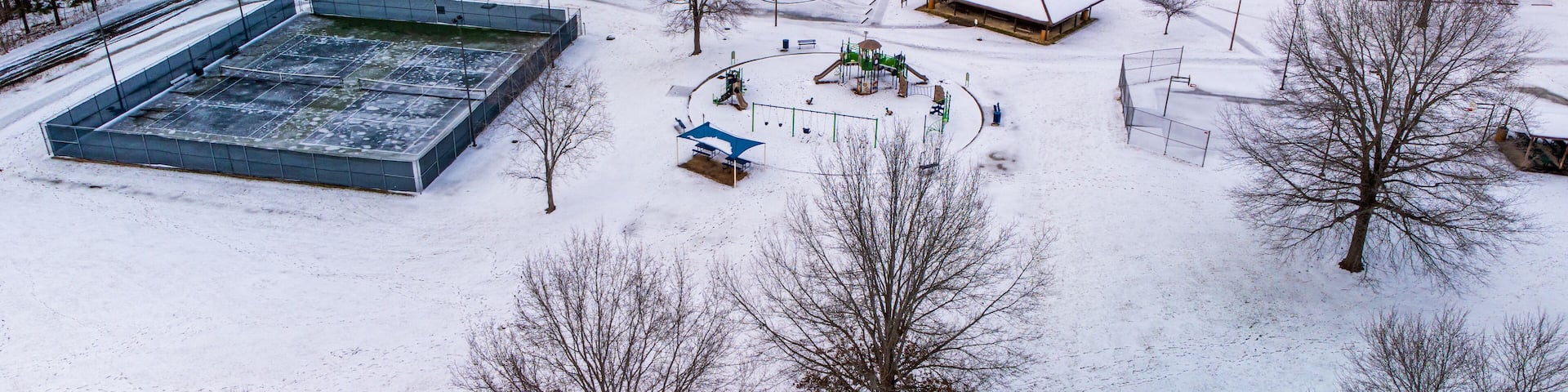 Aerial shot of a playground in Graham, North Carolina during winter with snowy ground