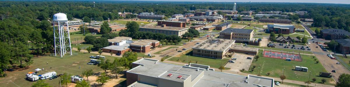 aerial shot of a gorgeous autumn landscape at Grambling State University with red brick buildings across the campus, water towers and lush green trees and grass in Grambling Louisiana USA