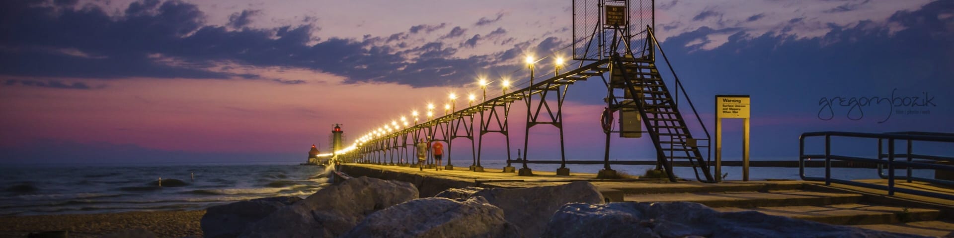 Grand Haven which includes a sunset and rocky coastline