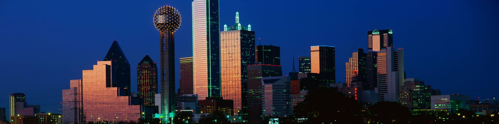 This is the skyline at dusk. It shows the Reunion Tower which is 50 stories high.