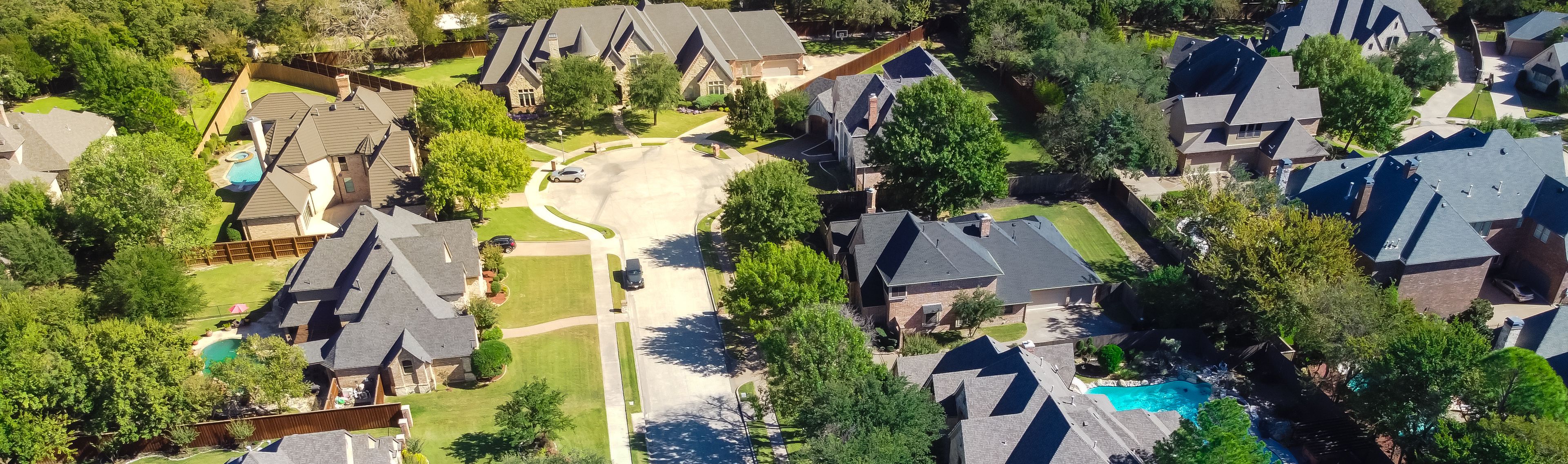 Panoramic top view expensive two story mansion houses with swimming pools near a cul-de-sac in Grapevine, Texas, USA