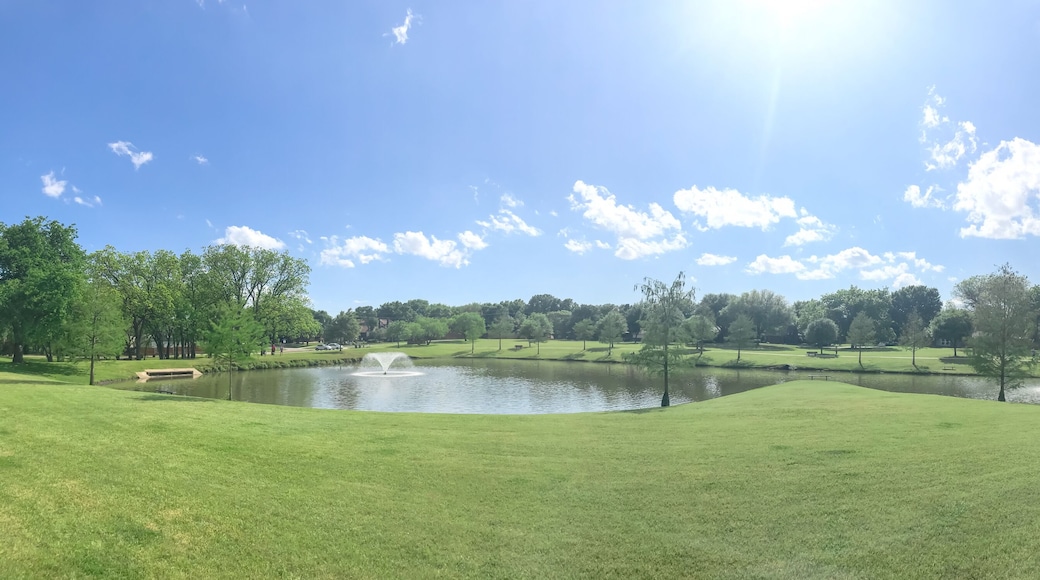 Large neighborhood park double water fountains pond near Dallas, Texas, USA cloud sky