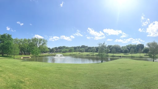 Large neighborhood park double water fountains pond near Dallas, Texas, USA cloud sky