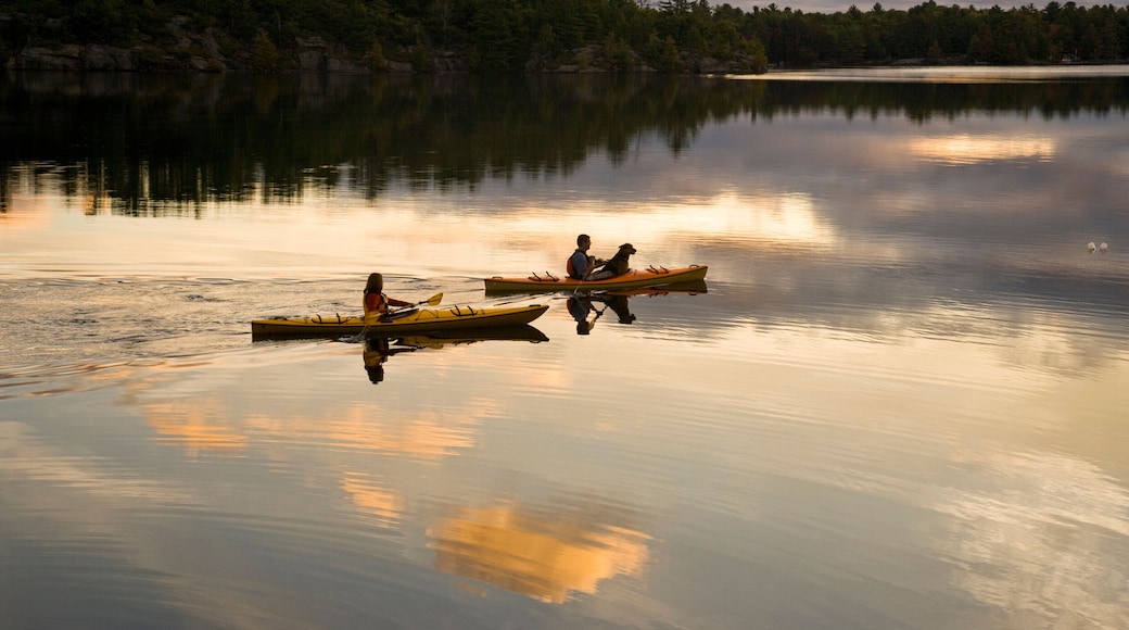 Young couple kayaking on Gull Lake near Gravenhurst, Ontario, Canada.
