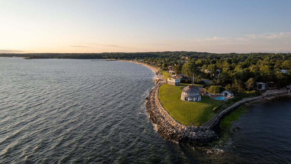 Aerial view of sunrise on island with green lawn and resort houses of Long Island, New York